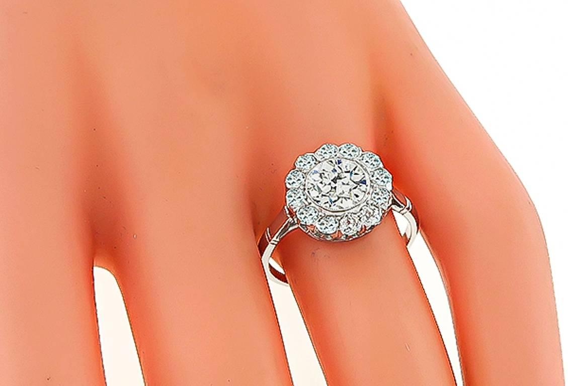 This elegant platinum engagement ring from the Victorian era, is centered with a sparkling GIA certified round cut diamond that weighs 1.17ct. graded J color with VS2 clarity. Accentuating the center stone are dazzling old mine cut diamonds that