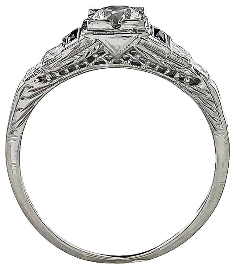 This amazing 18k white gold engagement ring from the 1920s. is centered with a sparkling GIA certified round cut diamond that weighs 0.53ct. graded G color with VS1 clarity. The center diamond is accentuated by lovely sapphire accents.
It is size 9