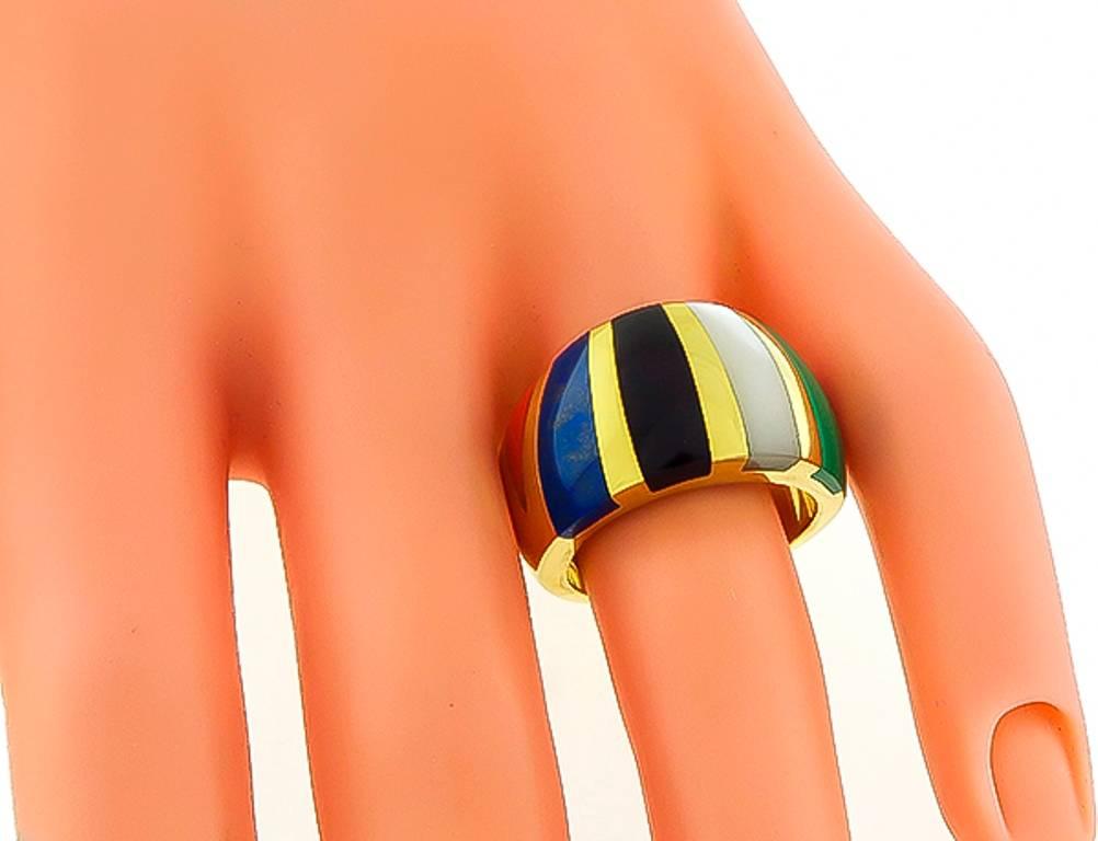 Made of 14k yellow gold, this ring features  mother of pearl, onyx, malachite, lapis and coral inlay. The ring has a tapering width from 6mm to 13mm. It is stamped 14K 0A/G and weighs 11 grams.
The ring is size 7 1/2, and can be