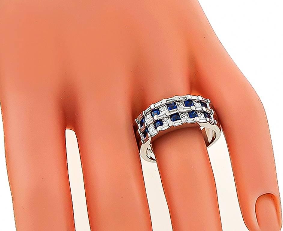 This elegant 18k white gold ring is set with sparkling princess and baguette cut diamonds that weigh approximately 0.80ct. graded G color with VS clarity. Accentuating the diamonds are even colored princess cut sapphires that weigh approximately