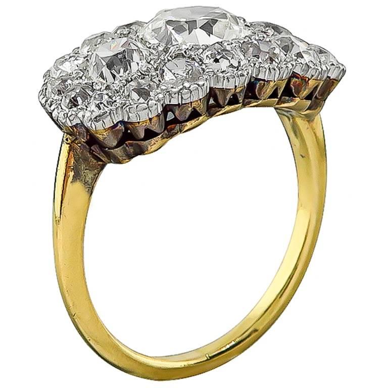 This amazing 18k yellow and white gold ring from the Victorian era, is centered with a sparkling old mine cut diamond that weighs 1.03ct. graded I-J color with VS1 clarity. Accentuating the center stone are dazzling old mine cut diamonds that weigh