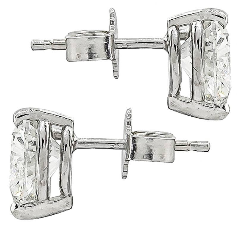 This stunning pair of 14k white gold stud earrings feature sparkling GIA certified heart brilliant cut diamonds that weigh 1.07ct and 1.05ct. The color of the diamonds is I with SI1 clarity and I with VVS2 clarity respectively. 
The earrings are