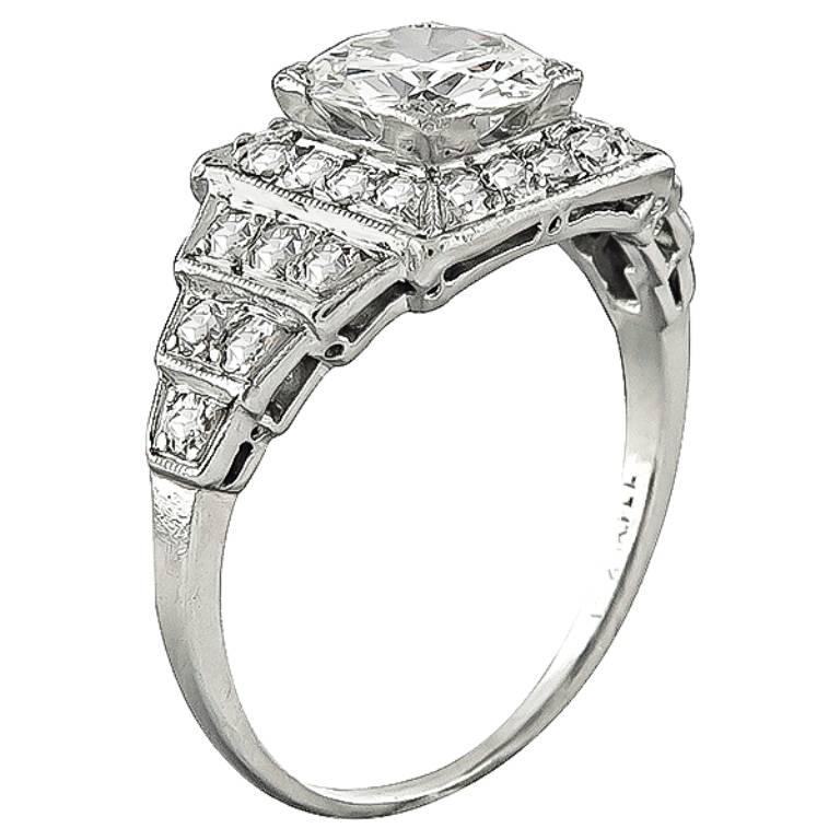 Made of platinum, this ring centers a sparkling GIA certified old mine cut diamond that weighs 1.15ct. graded I color with VS2 clarity. Accentuating the center stone are round cut diamonds that weigh approximately 0.75ct. graded G color with VS