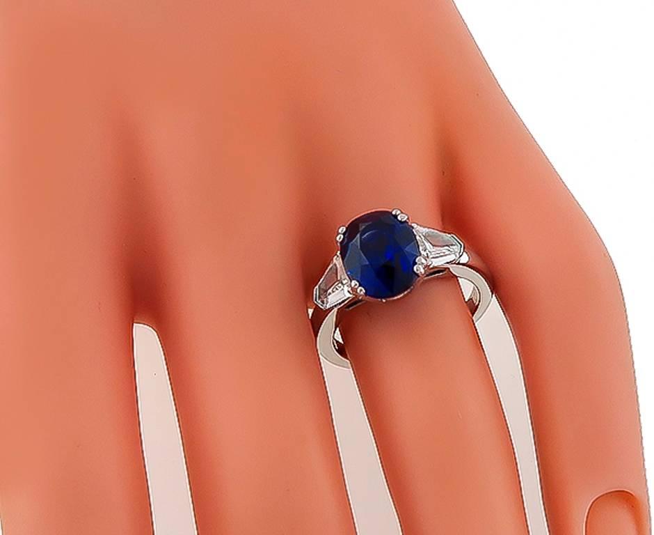 This amazing platinum engagement ring is centered with a royal blue GRS certified oval cut sapphire that weighs 4.04ct. The center stone is flanked by sparkling shield cut diamonds that weigh approximately 0.80ct. graded G color with VS1 clarity.