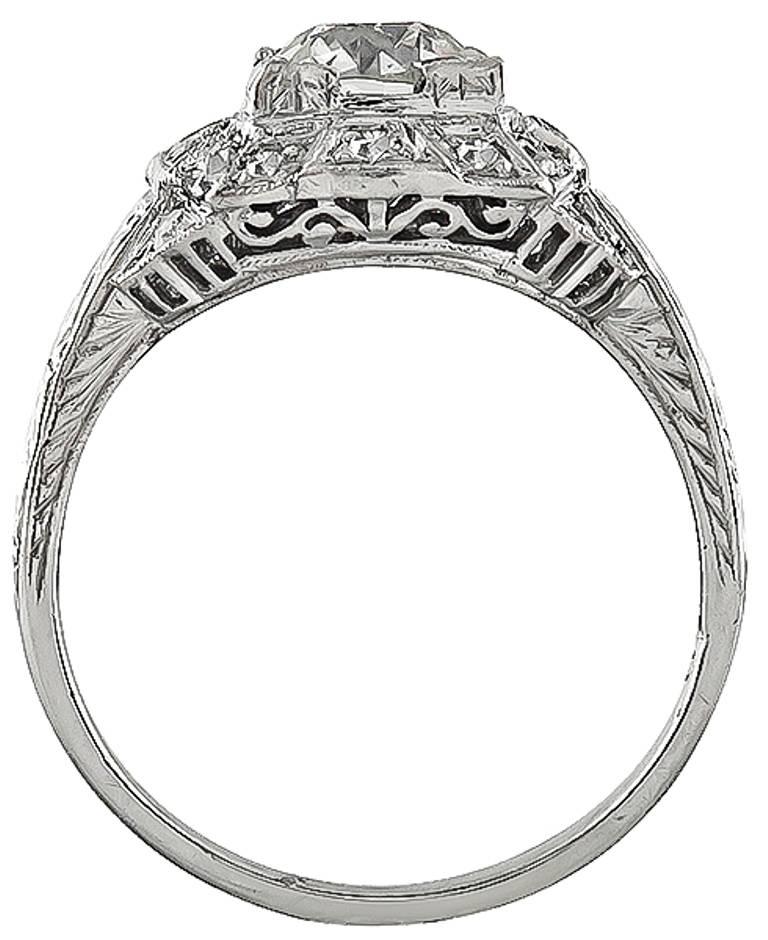 This amazing platinum engagement ring from the Art Deco era is centered with a sparkling GIA certified old European brilliant cut diamond that weighs 1.02ct. graded K color with VS2 clarity. Accentuating the center stone are dazzling round cut