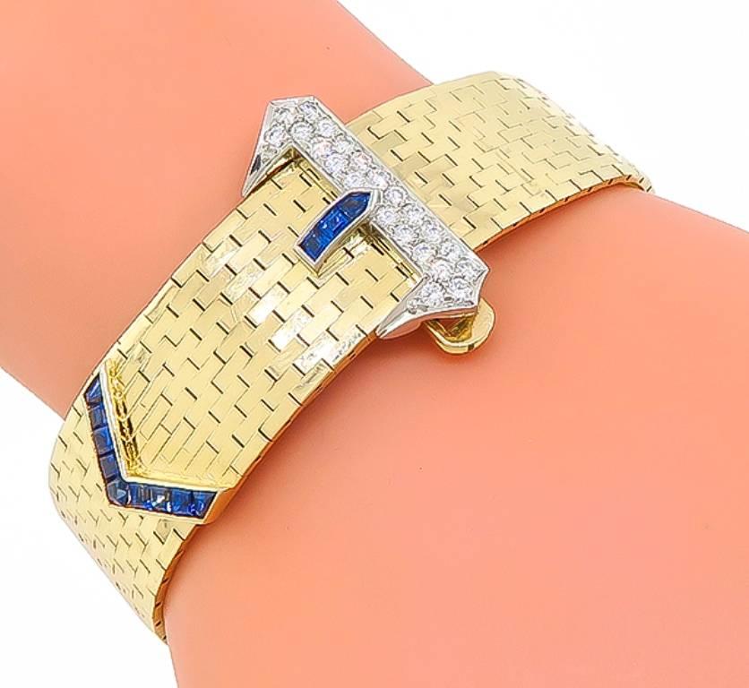 This 14k yellow and white gold belt bracelet by Tiffany & Co is set with sparkling round cut diamonds that weigh approximately 0.80ct. graded F color with VS1 clarity. Accentuating the diamonds are high quality blue sapphire accents. The