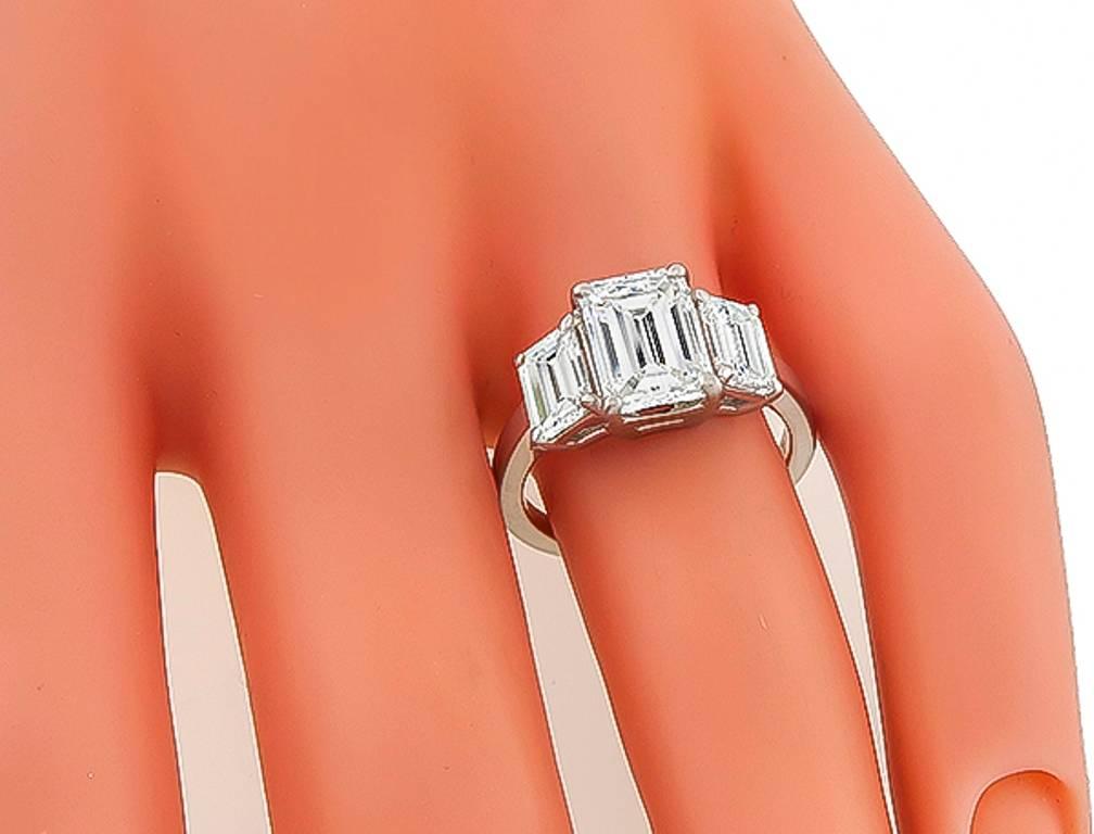This amazing platinum ring is centered with a sparkling GIA certified emerald cut diamond that weighs 2.10ct. graded H color with VVS2 clarity. The center stone is flanked by dazzling emerald cut diamonds that weigh approximately 1.50ct. graded H-I