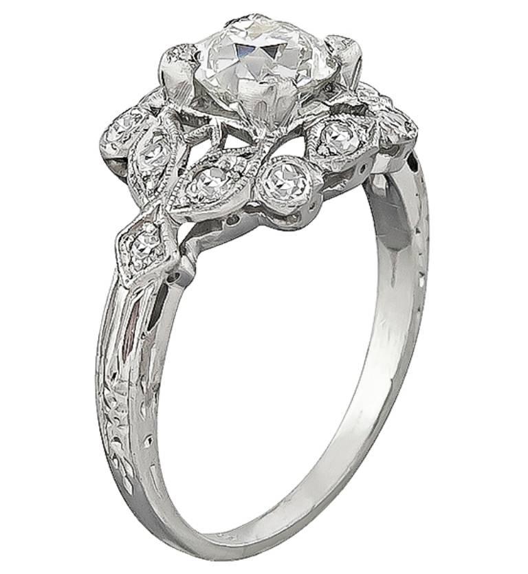 This elegant platinum engagement ring centers a sparkling GIA certified old mine brilliant cut diamond that weighs 0.97ct. graded J color with VS1 clarity. Accentuating the center stone are dazzling round cut diamond accents. The ring is stamped 10%