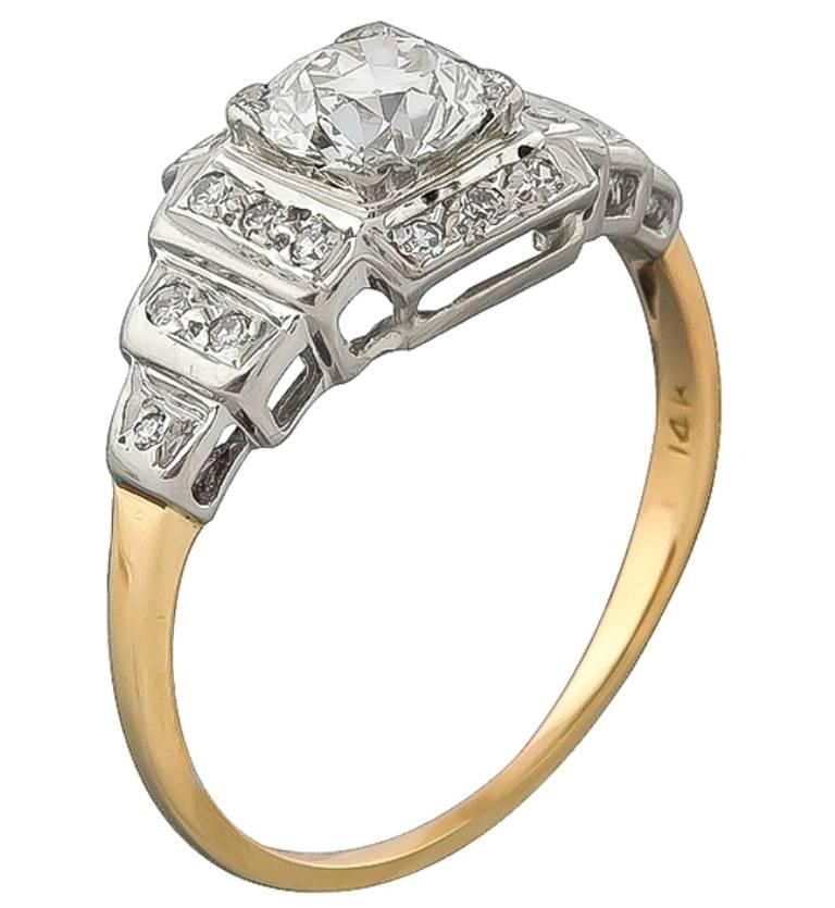 This amazing 14k yellow and white gold engagement ring is centered with a sparkling GIA certified circular brilliant cut diamond that weighs 0.70ct. graded K color with VS1 clarity. Accentuating the center stone are high quality round cut diamond