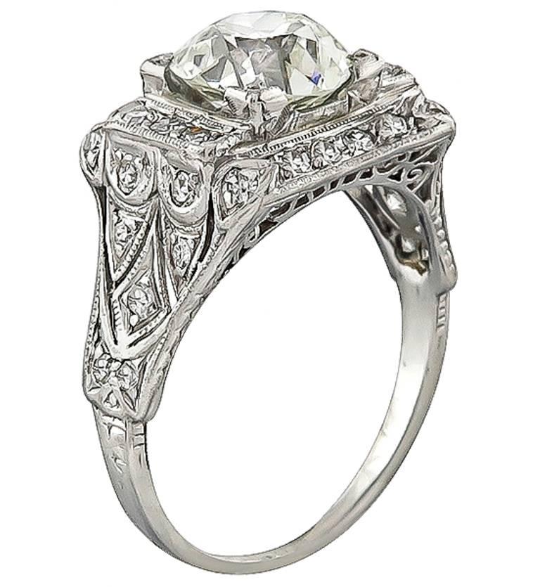 This stunning platinum engagement ring from the Art Deco era, is centered with a sparkling GIA certified old European cut diamond that weighs 2.14ct. graded L color with VS1 clarity. Accentuating the center stone are high quality round cut diamond