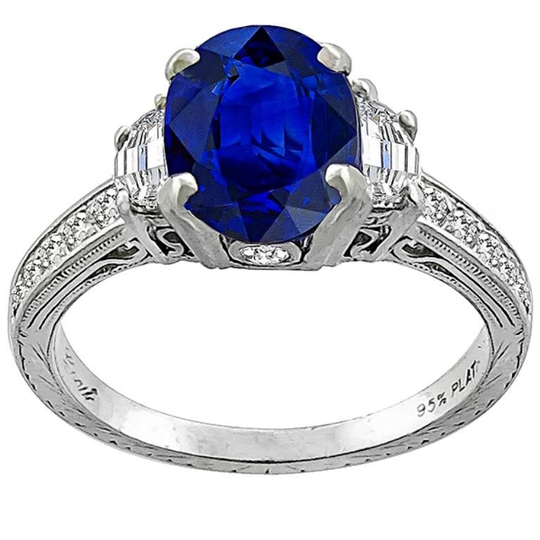 Made of platinum, this ring is centered with a natural oval cut sapphire that weighs 2.30ct. The sapphire is flanked by 2 sparkling half moon cut diamonds weighing approximately 0.35ct. graded F color with VS clarity.
It is currently size 6, and can