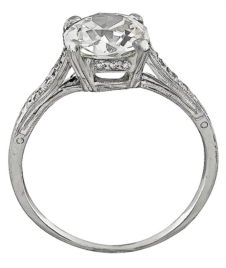 This elegant platinum engagement ring is centered with a sparkling GIA certified old mine cushion cut diamond that weighs 1.81ct. graded J color with SI1 clarity. Accentuating the center stone are dazzling round cut diamond accents.
The ring is