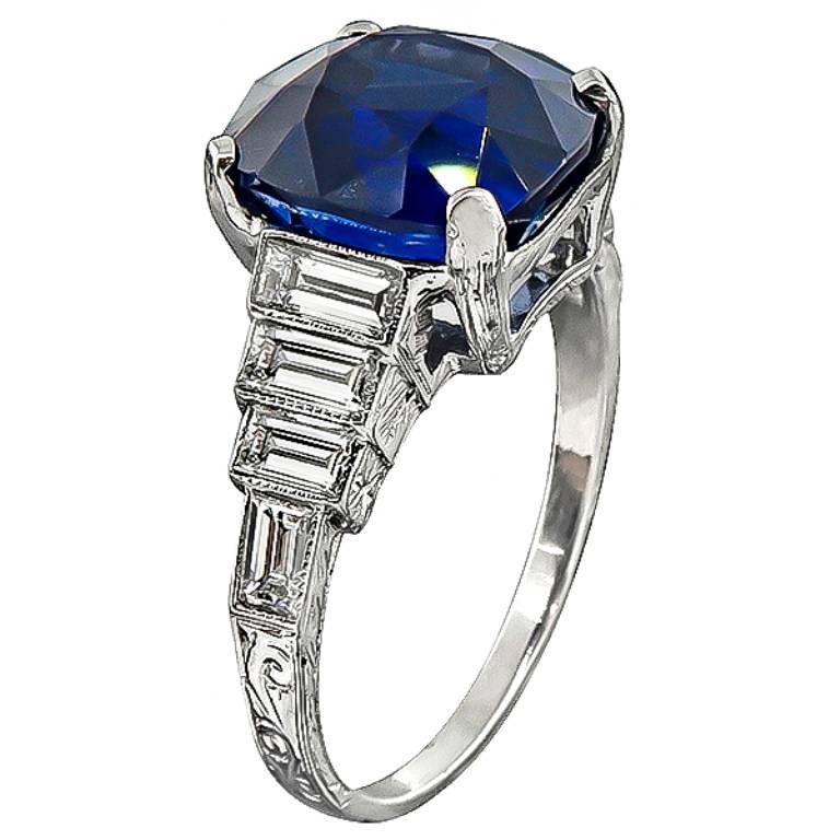 This amazing platinum engagement ring from the Art Deco era, is centered with a natural cushion cut sapphire that weighs 6.23ct. Accentuating the sapphire are sparkling baguette cut diamonds that weigh approximately 1.00ct. graded F-G color with VS