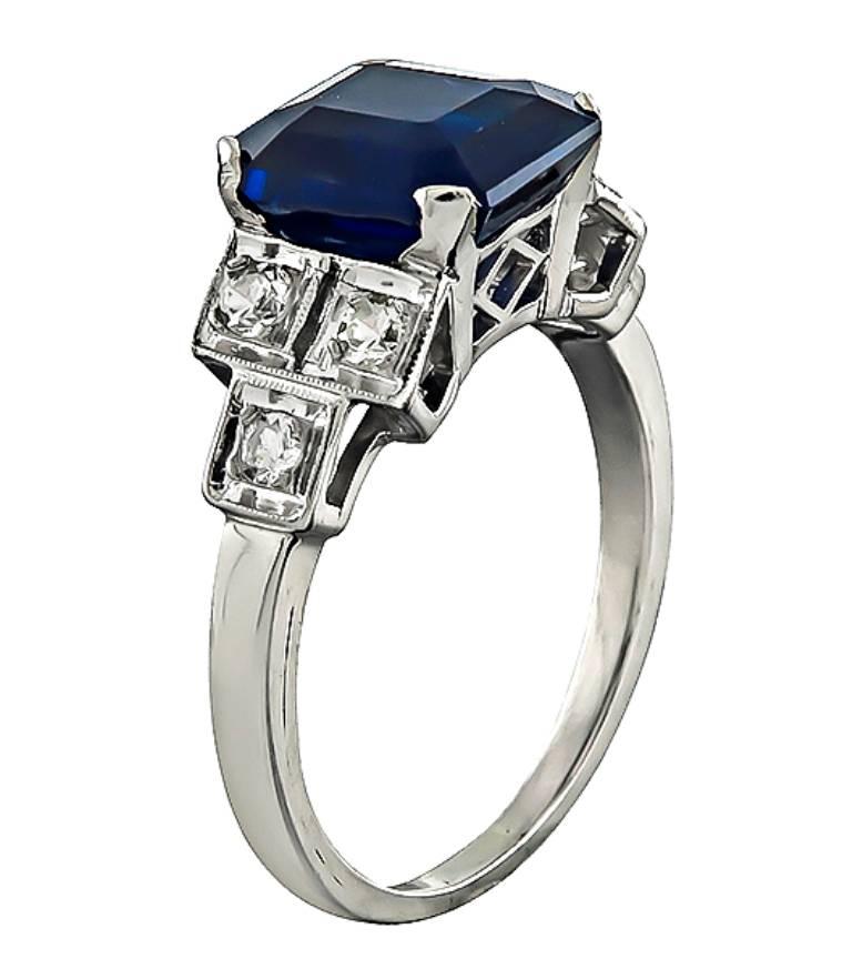 This stunning platinum ring is centered with a lovely asscher cut sapphire that weighs 4.16ct. Accentuating the sapphire are dazzling diamond accents. The top of the ring measures 9mm by 15mm. It is currently size 6 3/4, and can easily be