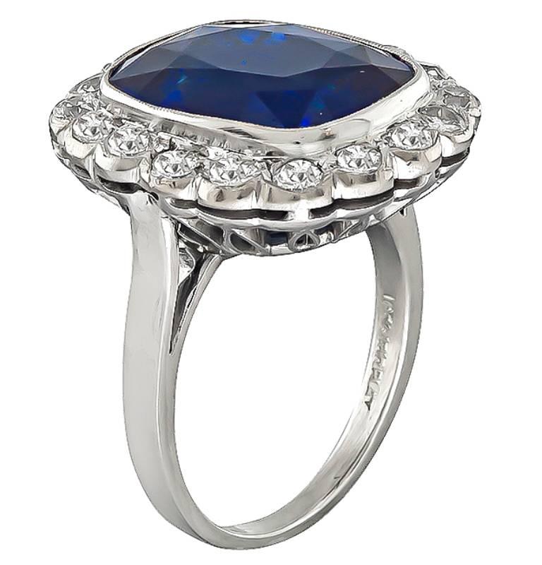 This stunning platinum ring is centered with a lovely cushion cut sapphire that weighs 10.30ct. The sapphire is accentuated by sparkling old mine cut diamonds that weigh approximately 1.25ct. graded G color with VS clarity. The top of the ring