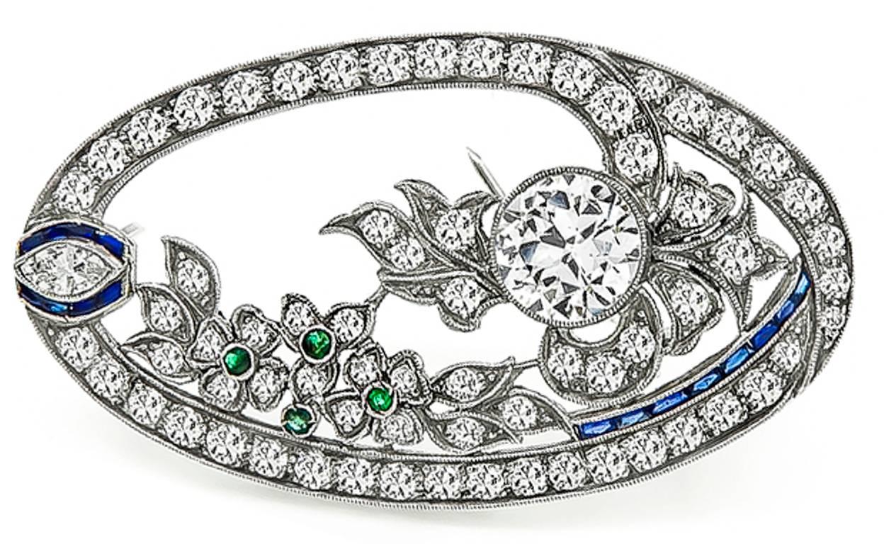 This unique platinum pin from the Art Deco era, is centered with a sparkling old mine cut diamond that weighs approximately 1.65ct. graded I-J color with SI3 clarity. Accentuated the center stone are round and marquise cut diamonds that weigh
