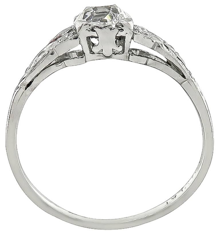 This elegant platinum engagement ring from the Art Deco era, is centered with a sparkling GIA certified old mine cut diamond that weighs 0.79ct. graded G color with VS1 clarity. Accentuating the center stone are dazzling round cut diamond accents.