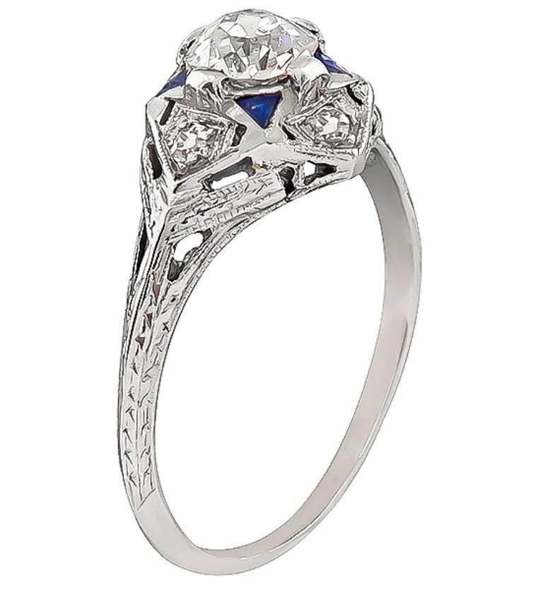 Made of 18K white gold, this ring is centered with a sparkling GIA certified old European cut diamond that weighs 0.65ct. graded H color with SI1 clarity. The center diamond is accentuated by sapphire and diamond accents.
It is currently size 8 1/4,