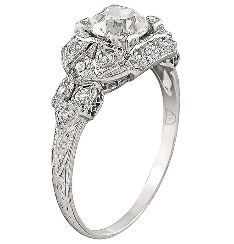 This charming platinum engagement ring from the Art Deco era is centered with a sparkling GIA certified old European cut diamond that weighs 1.00ct. graded J color with VS1 clarity. The center diamond is accentuated by dazzling round cut diamond