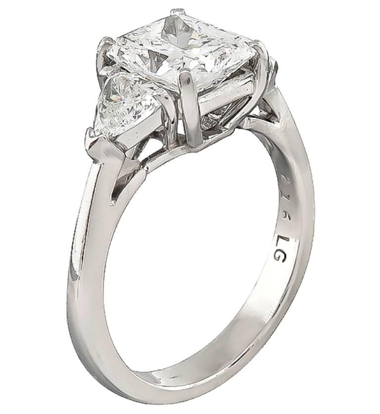 This gorgeous platinum engagement ring is centered with a sparkling GIA certified radiant cut diamond that weighs 2.16ct. graded G color with VS1 clarity. The center diamond is flanked by two trilliant cut diamonds that weigh approximately 0.75ct.