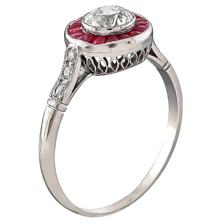 This fabulous platinum engagement ring is centered with a sparkling GIA certified old mine cut diamond that weighs 0.50ct. graded H color with VS2 clarity. The center diamond is accentuated by ruby and diamond accents. The ring weighs 2.2 grams. It