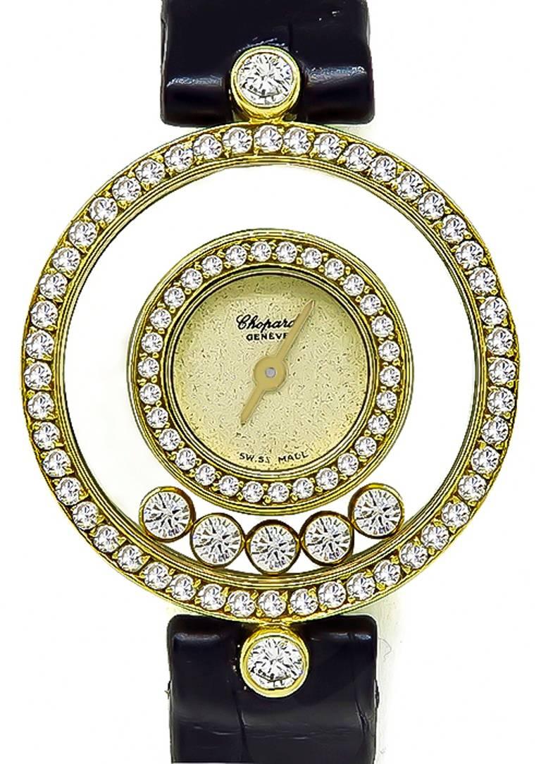 This elegant 18k yellow gold leather strap Happy Diamonds ladies watch by Chopard, features a champagne dial, inner 18k gold bezel set, 5 round cut floating diamonds in between both bezels, sapphire glass and quartz movement. The total approximate