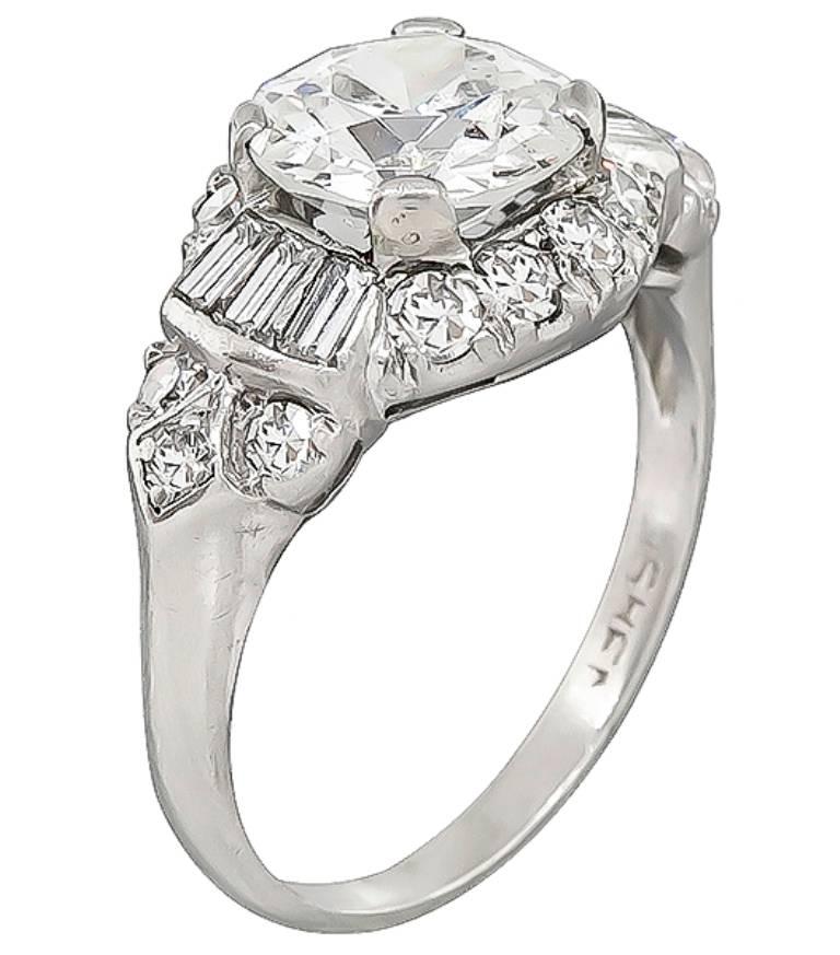 This amazing platinum engagement ring from the Art Deco era is centered with a sparkling GIA certified old mine cut diamond that weighs 1.60ct. graded F color with I1 clarity. Accentuating the center stone are dazzling baguette and round cut diamond