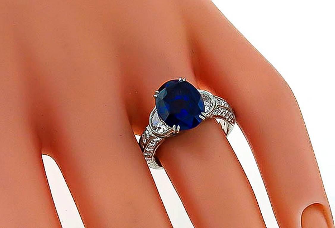 This elegant platinum ring is centered with a vivid blue oval cut Ceylon sapphire that weighs 4.71ct. The sapphire is accentuated by sparkling half moon and round cut diamonds weighing approximately 1.20ct. graded F color with VS clarity. The ring