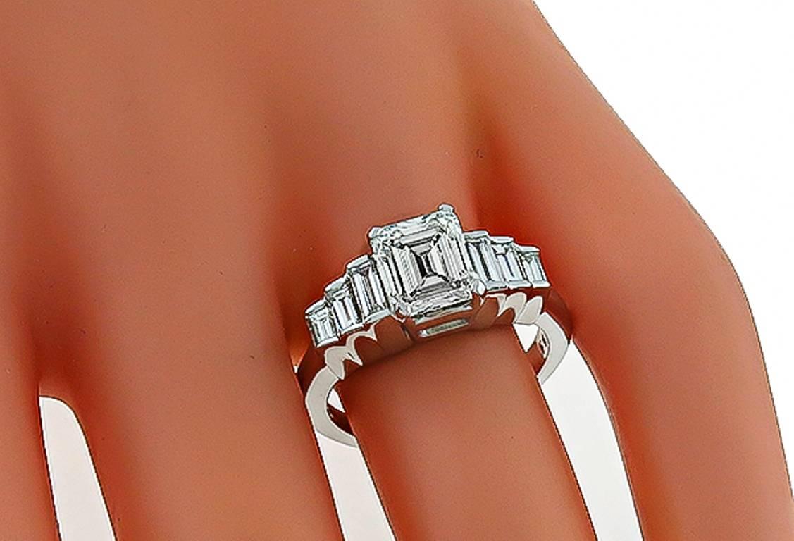 Made of 14k white gold, this ring centers a sparkling GIA certified emerald cut diamond that weighs 2.01ct. graded I color with VS2 clarity. The center diamond is accentuated by dazzling baguette cut diamonds that weigh approximately 0.50ct. The