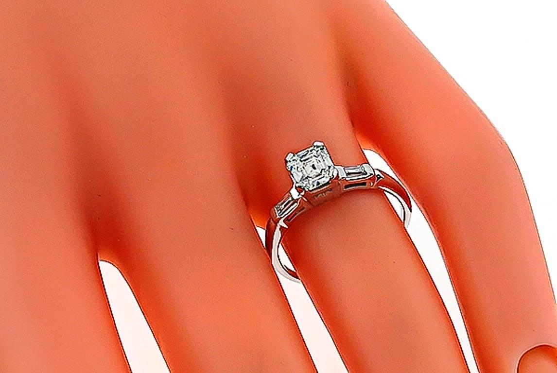 This elegant 14k white gold engagement ring is centered with a sparkling GIA certified emerald cut diamond that weighs 0.95ct. graded J color with VVS1 clarity. The center flanked by dazzling baguette cut diamond accents.
The ring is size 5 1/2,