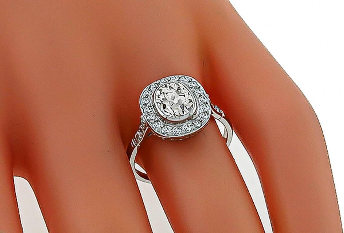 This fabulous platinum ring from the Art Deco era, is centered with a sparkling GIA certified old mine brilliant cut diamond that weighs 1.45ct. and is graded J color with SI1 clarity. The center stone is accentuated by dazzling old mine cut