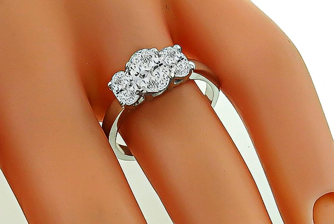 This stunning 14k white gold ring is centered with a sparkling GIA certified oval cut diamond that weighs 0.78ct. and is graded D color with SI2 clarity. The center stone is accentuated by two dazzling oval cut diamonds that weigh approximately
