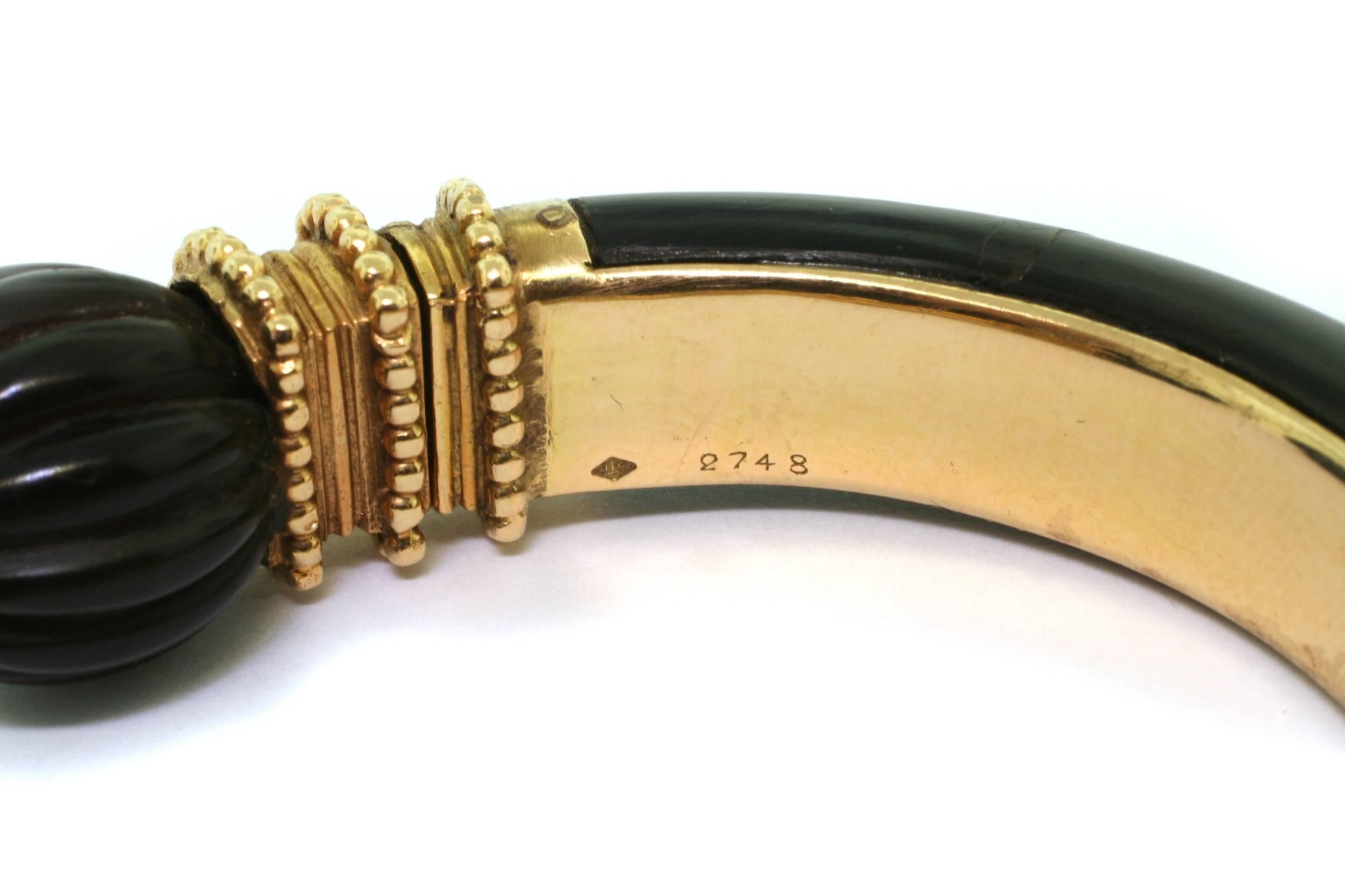 Tiger Eye, Wood and Gold

Each terminal of the ivory bangle is decorated with a carved wood boule and hinged 18 carat beaded yellow gold band
 
Boucheron is a French jewelry house founded in 1858 by Frédéric Boucheron, As  a visionary, in addition
