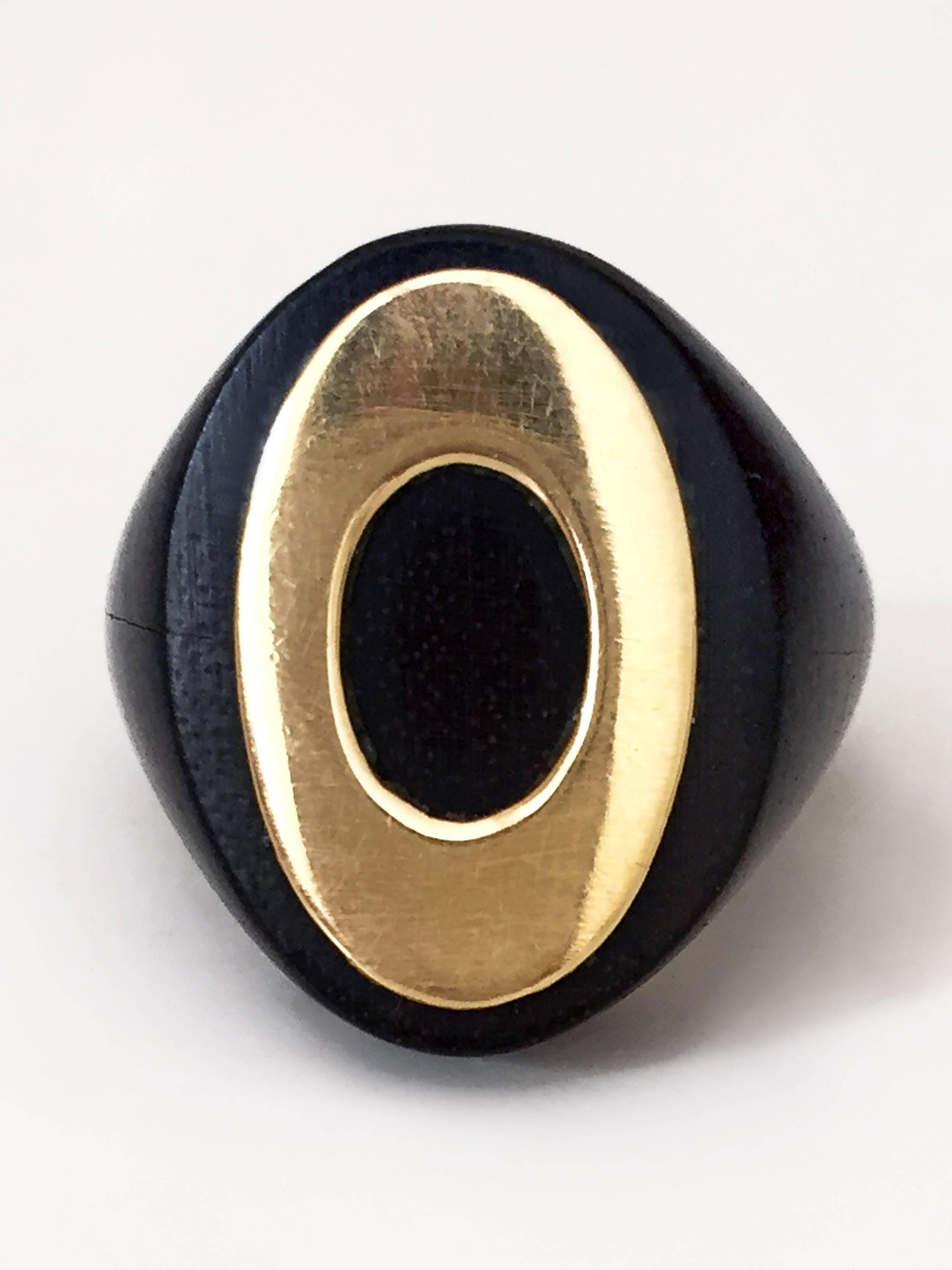 Van Cleef & Arpels wood and gold chevaliere ring
Size: 47 European, 4 US 

Signed VCA - Numbered 118010