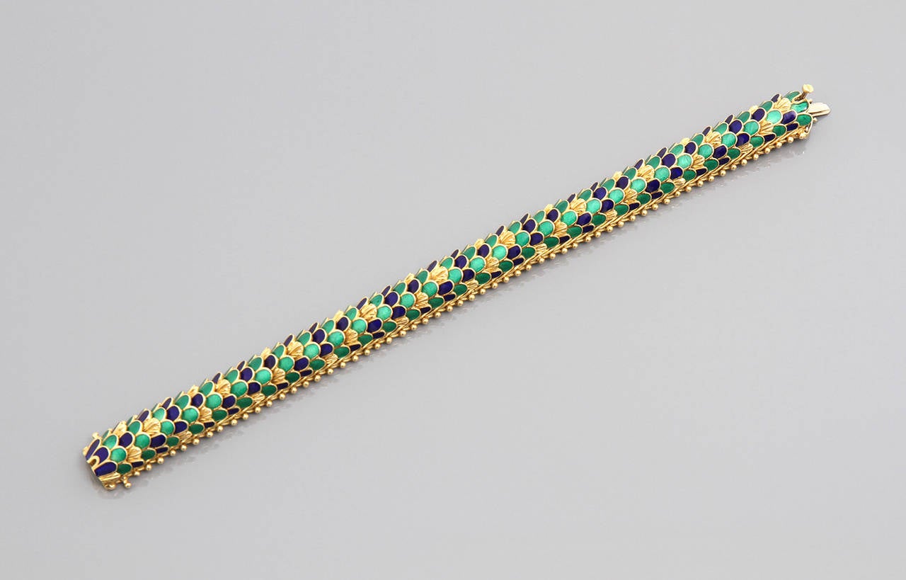 A gold and enamel bracelet designed as a series of overlapping scales.

Marked 18k