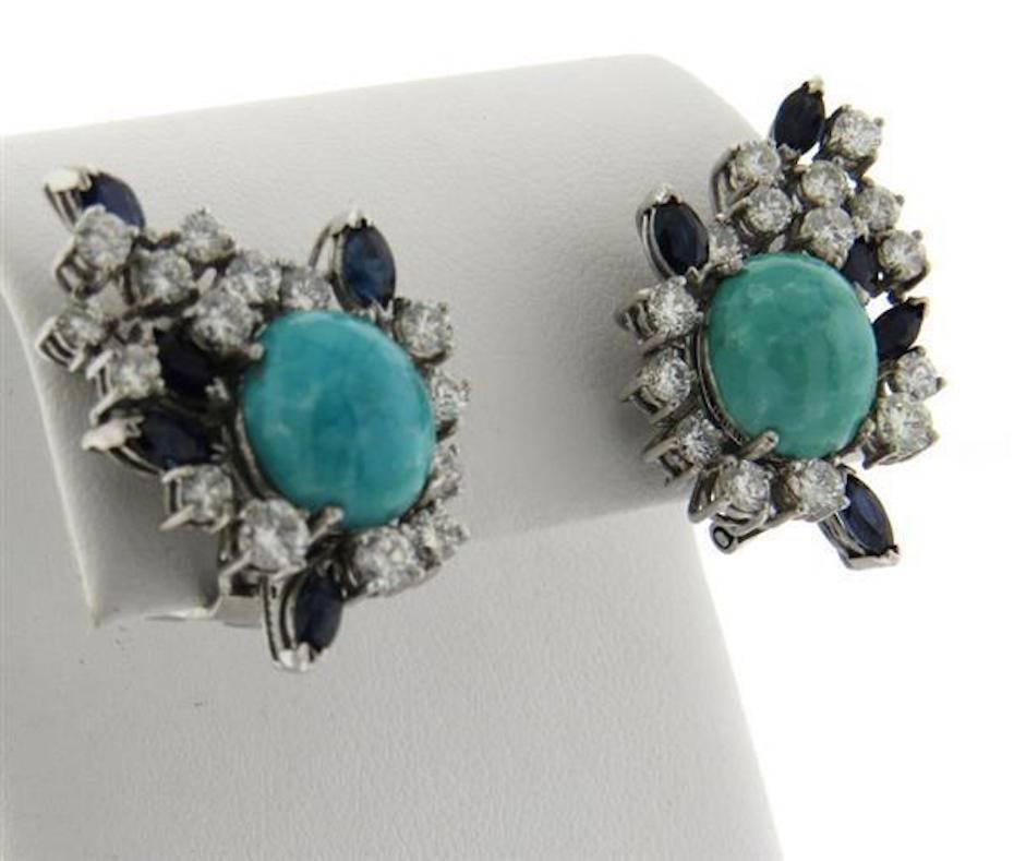 Stunning vintage 1960s clip earrings featuring turquoise cabochons with 2.50 carats of G-H/VS Diamonds and Sapphires set in 18k Gold.  The earrings are a generous size of 29mm x 21mm. They are decorated with marquis cut sapphires, 11mm x 10mm