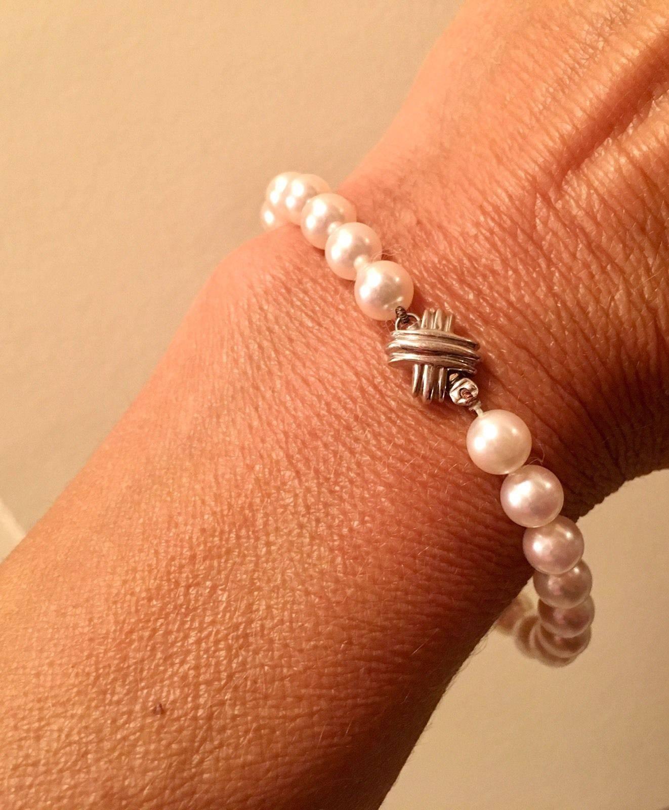 Stunning 18k white gold Tiffany & Co. high grade cultured pearl bracelet, set with the iconic signature x clasp, indicating the bracelet has pearls of the finest quality.  High metallic luster and shine, with a slight rose tint as only Tiffany