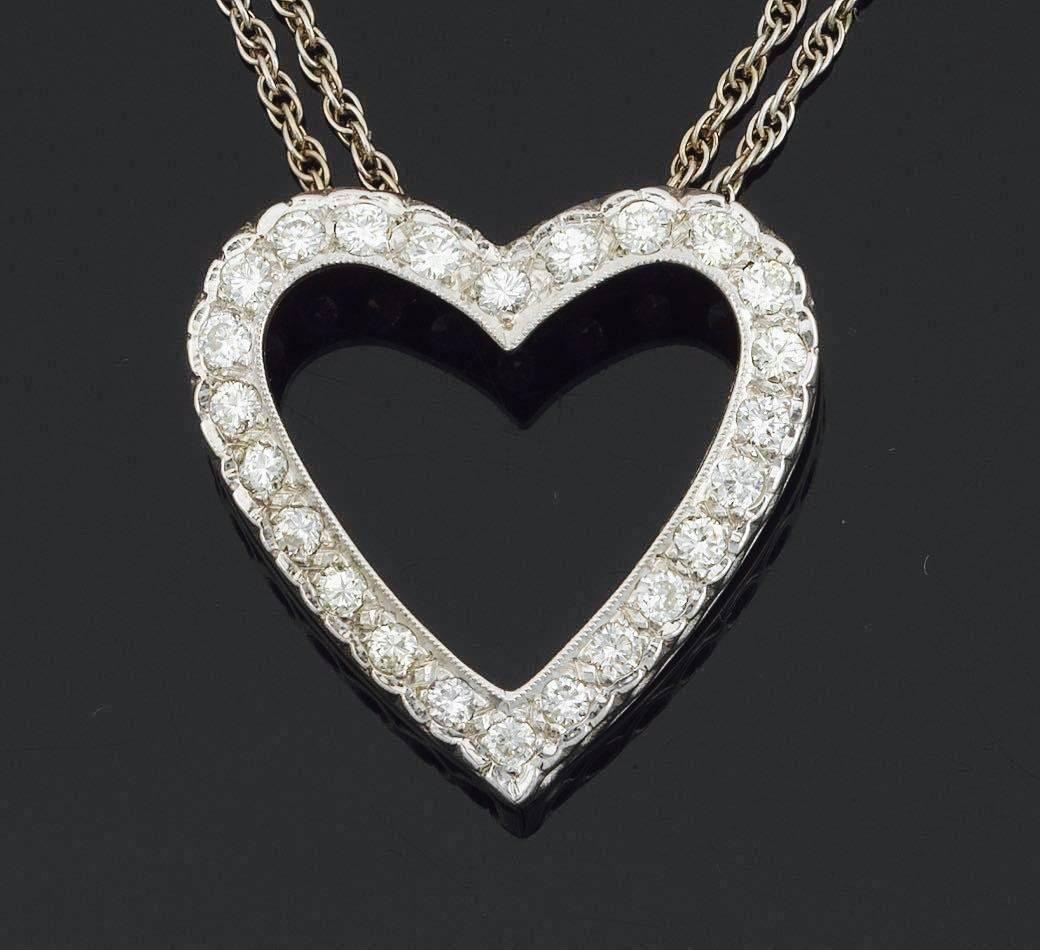 Lovely 14k white gold open heart pendant set with 0.75 carats of round brilliant cut diamonds, G-H VS1/SI1 quality.  The heart pendant measures 1