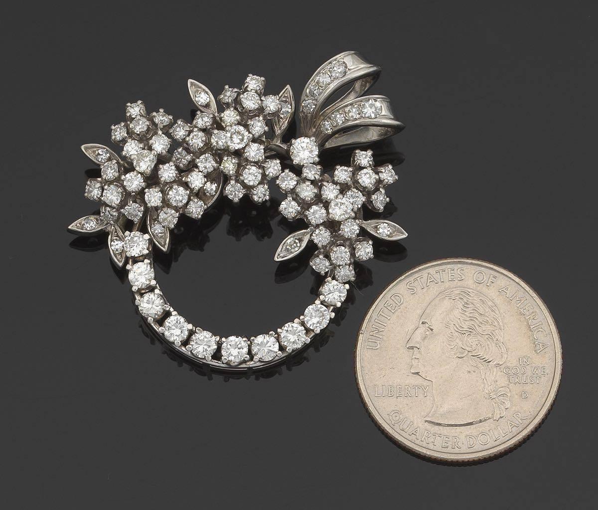 Impressive 1940's Art Deco 14 karat white gold wreath brooch / pin / pendant is a stunning example of a convertible brooch pendant.  

The piece features a dazzling array of 3.50 carats of sparkling round brilliant and single cut colorless VS/SI1