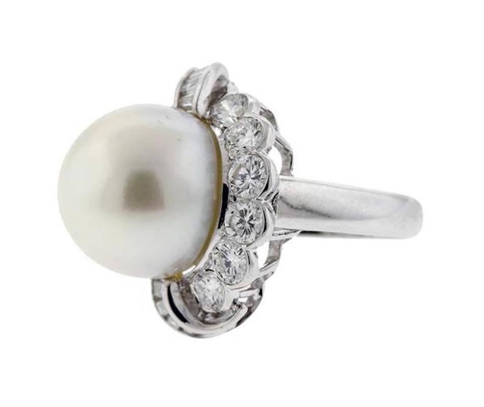 This ring bears a beautiful large South Seas pearl measuring 14.8mm, with approximately 2.00ctw of high quality G-H/VS brilliant cut round and baguette style diamonds.  The ring size is 6.5-6.75. The ring top measures 23mm x 21mm. The ring is marked
