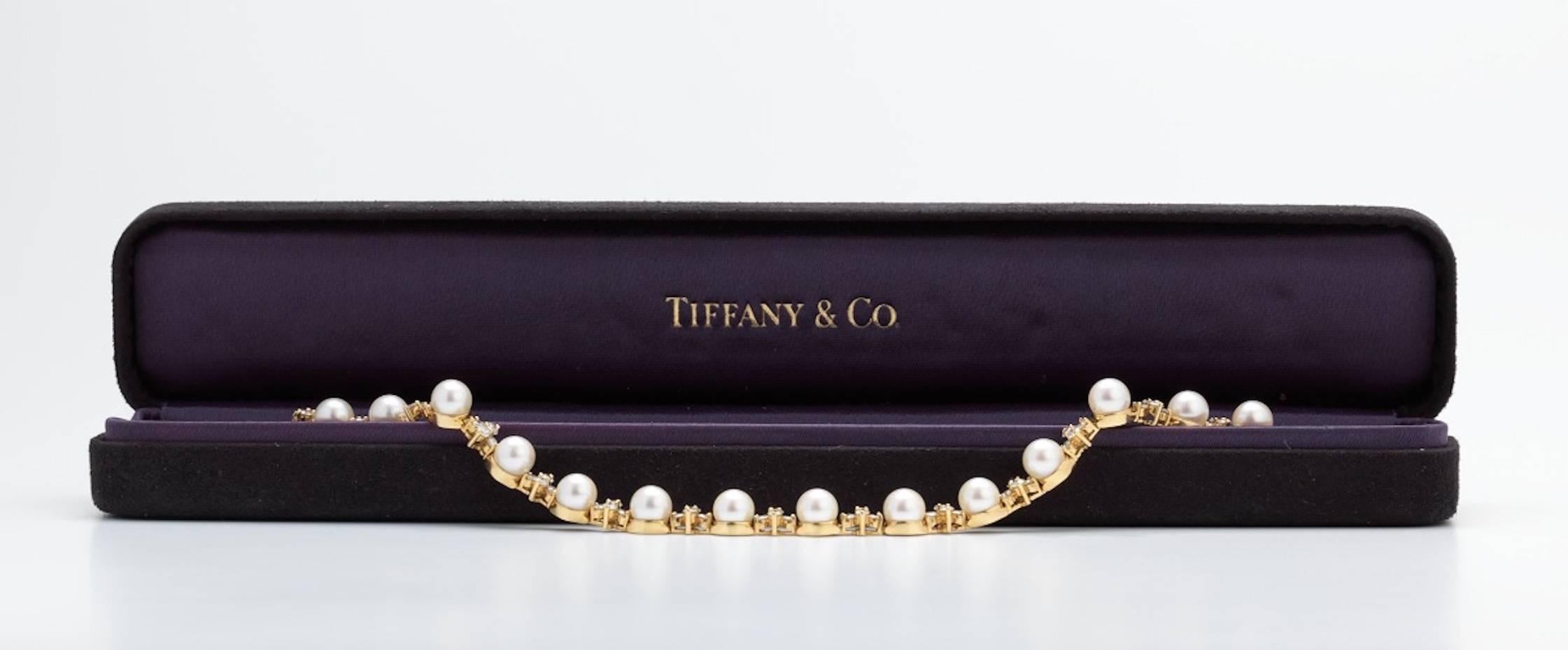 This iconic and rare stunning Tiffany & Co. bracelet is set in 18k gold (yellow) with an amazing array of alternating 6mm freshwater cultured pearls and alternating round brilliant cut diamond clusters.  The total estimated diamond weight is