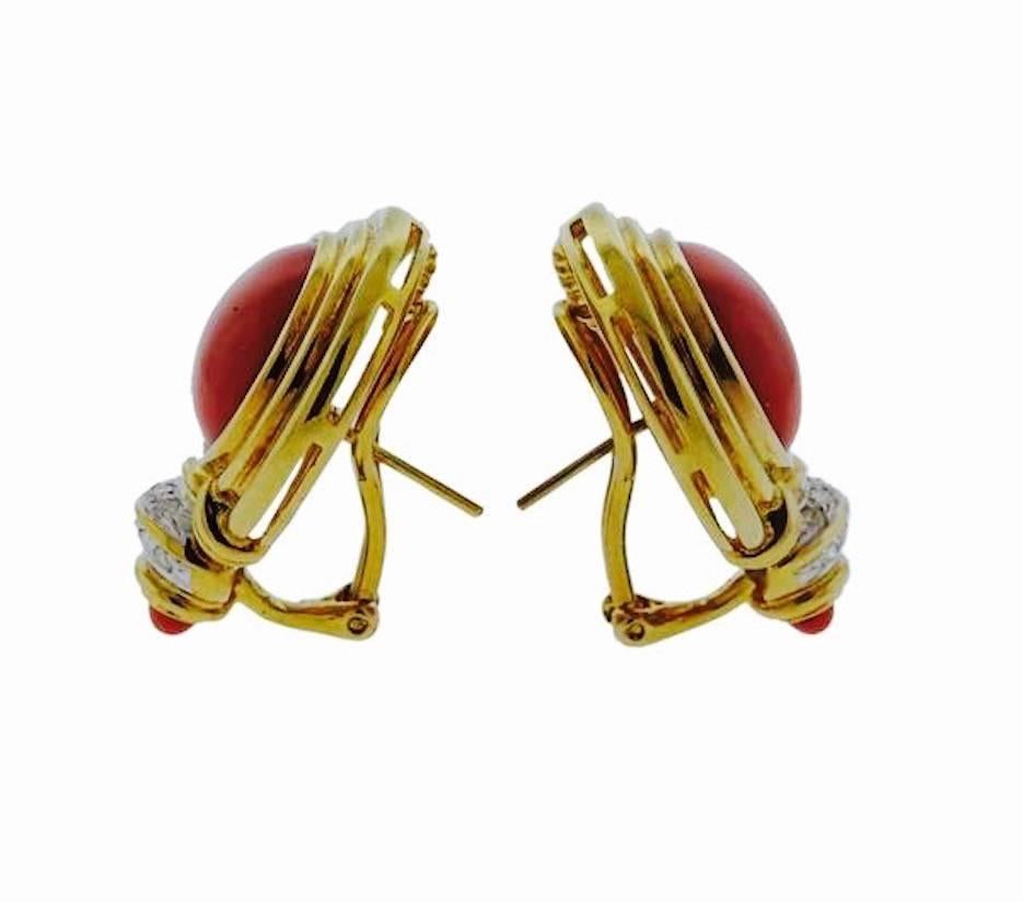 Beautiful and striking pierced earrings set in 18k gold with stunning red coral cabochons and diamond accents.  These will surely add color to any outfit.   The earrings are marked 750 AT and are sizable at 30mm long by 27 mm at the widest point. 
