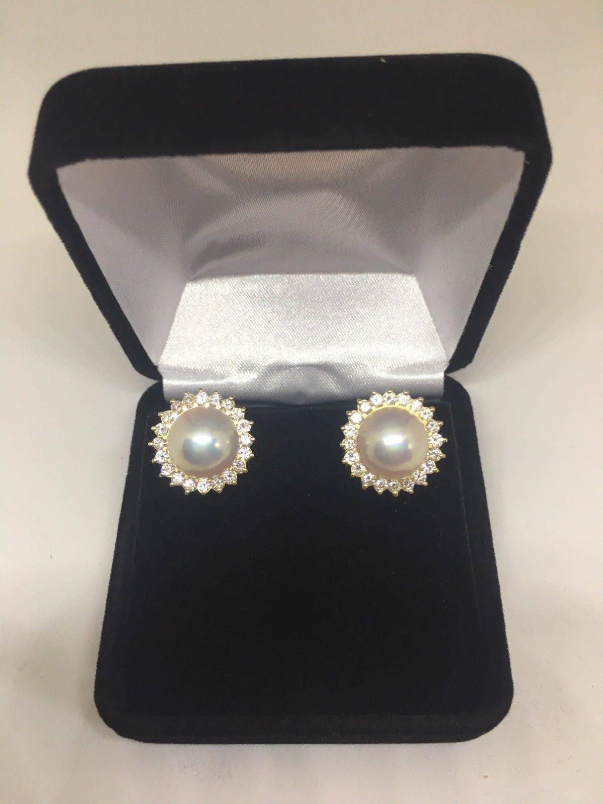  
Beautiful pair of 14k yellow gold mabe pearl and brilliant cut diamond halo earrings.  The earrings feature a halo of G/H VS quality diamonds centering a 20 mm mabe pearl.  The pierced earrings measure 3/4 " x 3/4 " and are fitted with