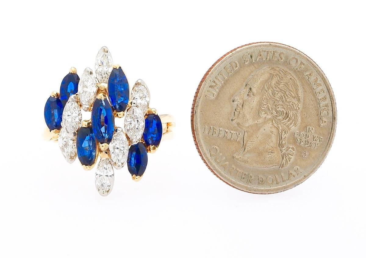 Beautiful Oscar Heyman Brothers vintage  platinum and 18K yellow gold cocktail ring, stepped set with marquise cut diamonds and blue sapphires. The total estimated diamond weight is 1.20 ct, of VS clarity and E/F color.   The total estimated