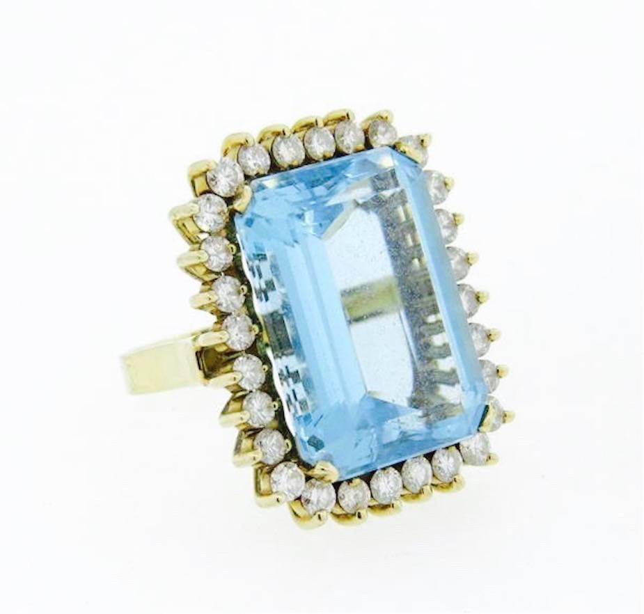 Lovely 14k Gold (tested) design with large 33 carat blue Topaz center and dazzling VS brilliant cut round gem quality diamonds totaling 1.40 cttw set into this beautiful ring!

The ring top is 29mm x 22mm and is a size 7 and can be easily resized. 