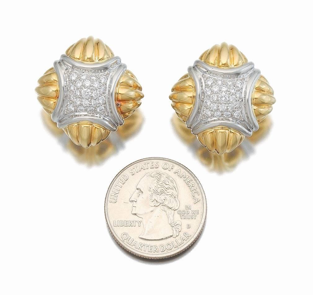 Stunning pair of Hammerman Brothers 18k yellow gold and platinum pair of earrings with omega backs, converted from clip earrings to post.  They are set with round brilliant cut diamonds, total estimated diamond weight of 1.00 carat of VS clarity, G