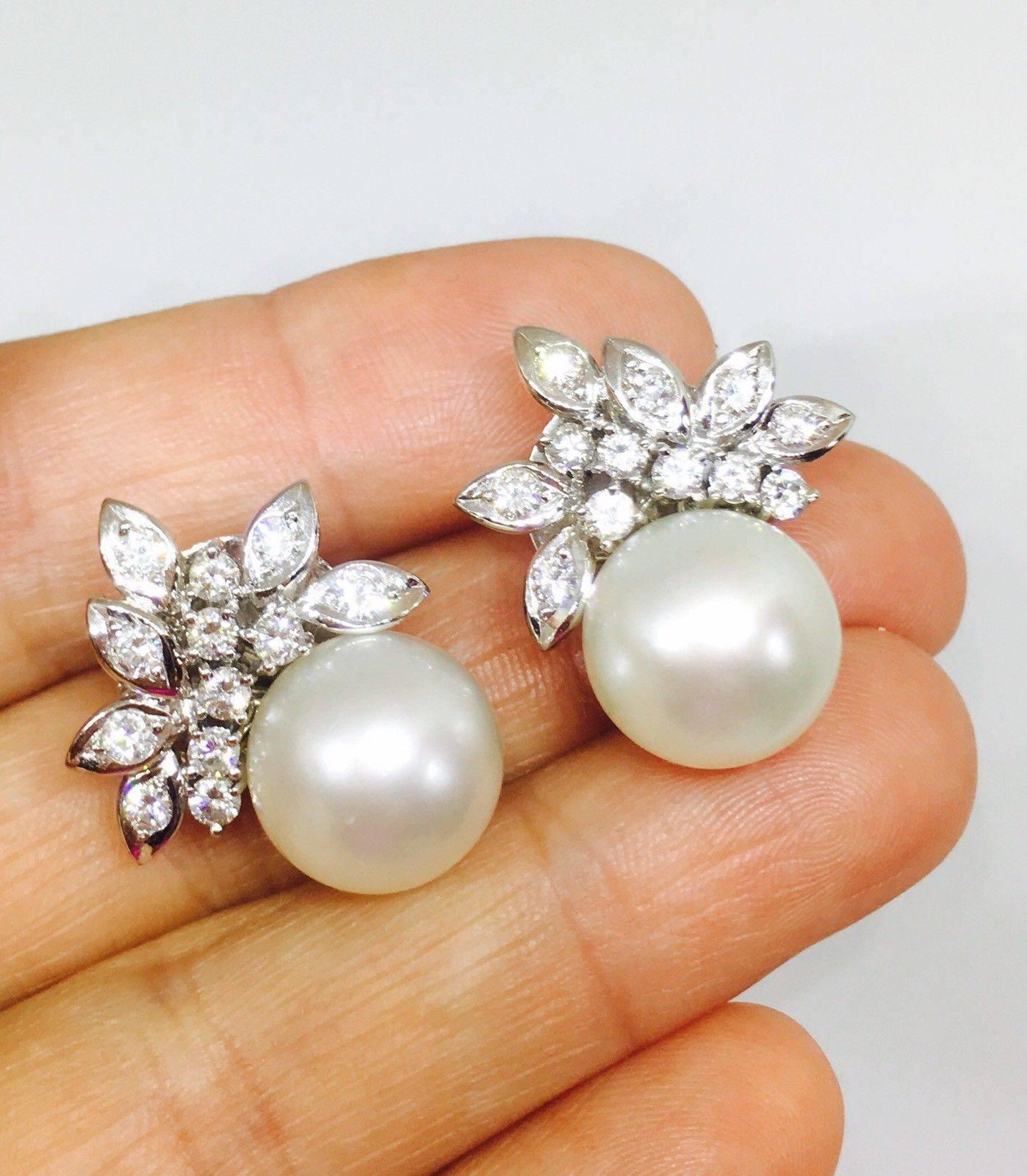Stunning 14k Gold Estate 13.2mm South Sea Pearl, 1.50 Carats Brilliant GH/VS Diamond Earrings

Beautiful 14k gold South Seas pearl and diamond cluster earrings sit perfectly on the ear, for the optimum sparkle and shine.  They are very active, fiery