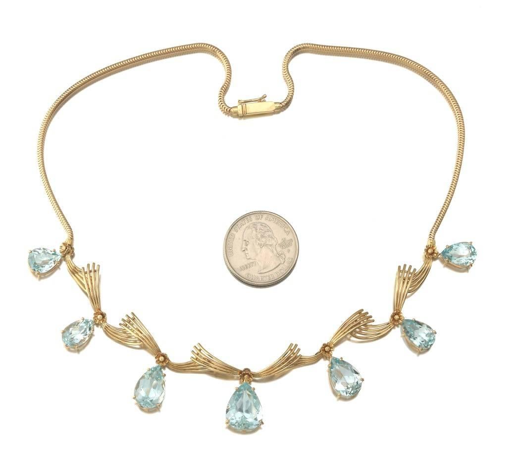 Stunning retro 18k gold snake link statement necklace features seven beautiful 
faceted-pear cut aquamarines.  The largest aquamarine drop measures 15.6mm x 11.65mm x 6.61mm, while the smallest one measures 11mm x 8.10mm x 5.09mm.  The aquamarines