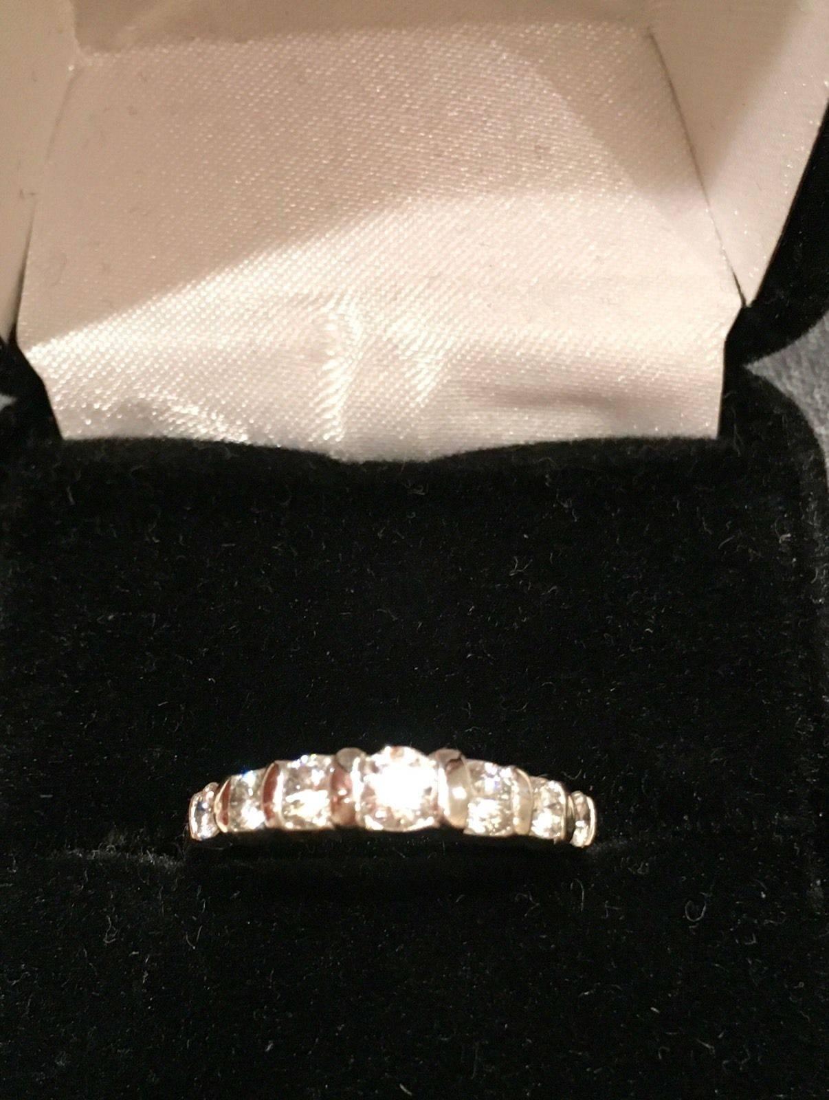 Vintage 1980s estate anniversary wedding band set with 0.80 carats of G/H VS brilliant cut round diamonds. The diamonds increase in size to the middle diamodn.  Two of these bands are available for purchase.  Estate wedding band procured from a