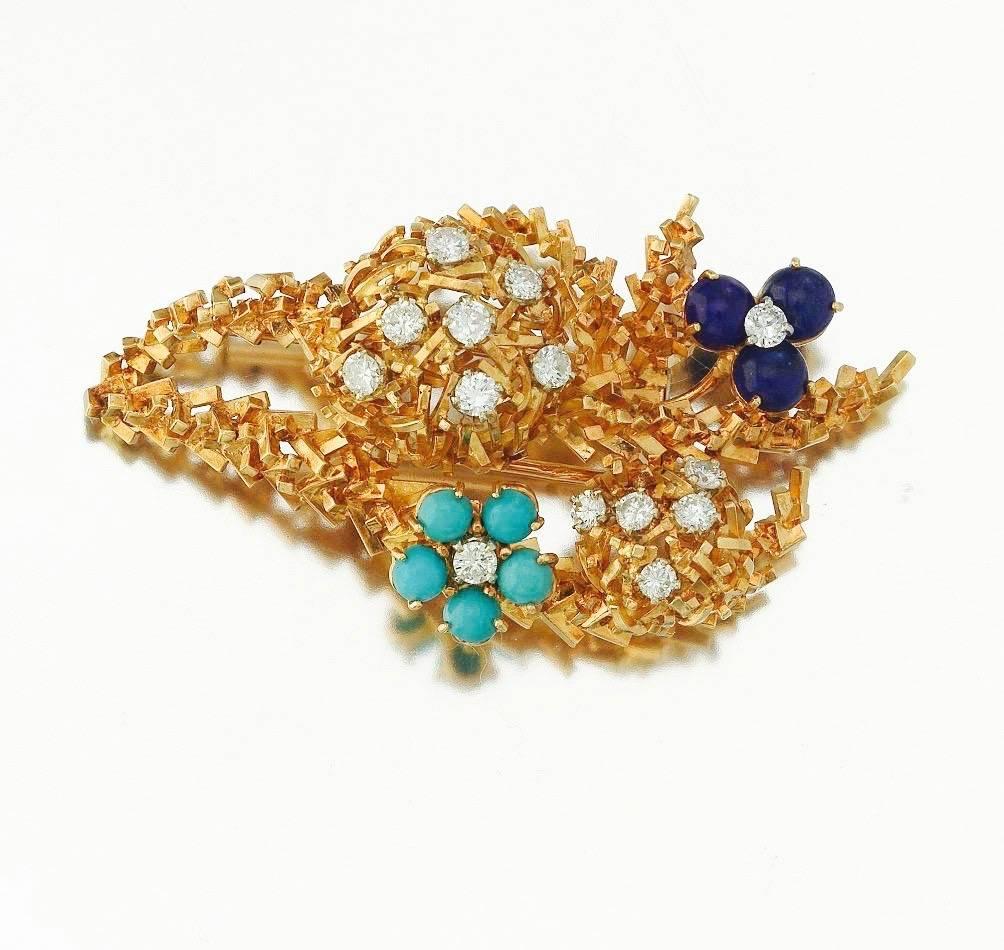 Stunning 18k yellow gold brooch of stylized flower bouquet, set with turquoise, lapis and round brilliant cut diamonds.  Total estimated diamond weight is 0.98cttw.  The brooch is signed 